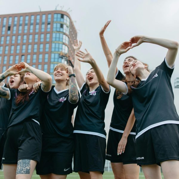 A cheering team of women on a soccer field